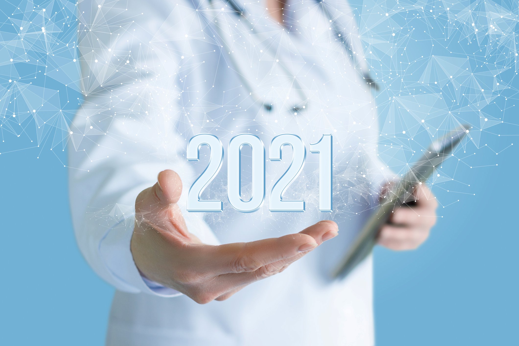 A doctor holds out his hand in the air and the number/year "2021" floats above it.
