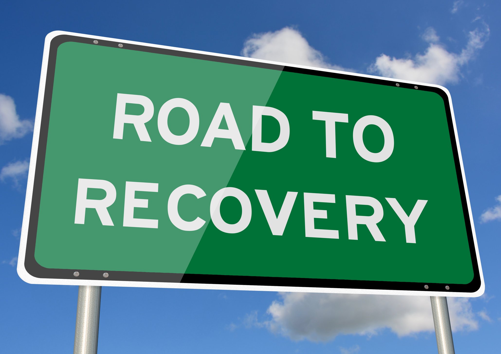 A green highway sign that says "Road to Recovery"