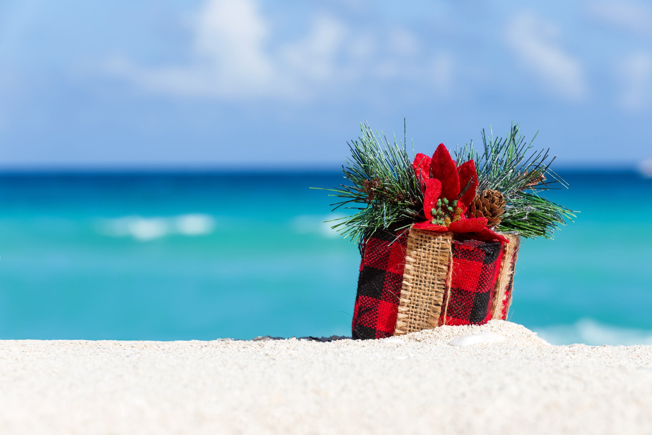 A wrapped present on the beach. 
