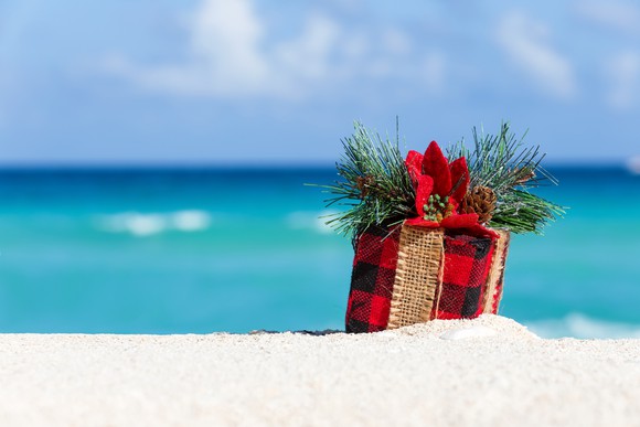 A wrapped present on the beach. 