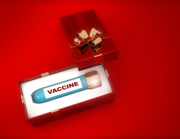 Red gift box containing a device labeled "vaccine." 