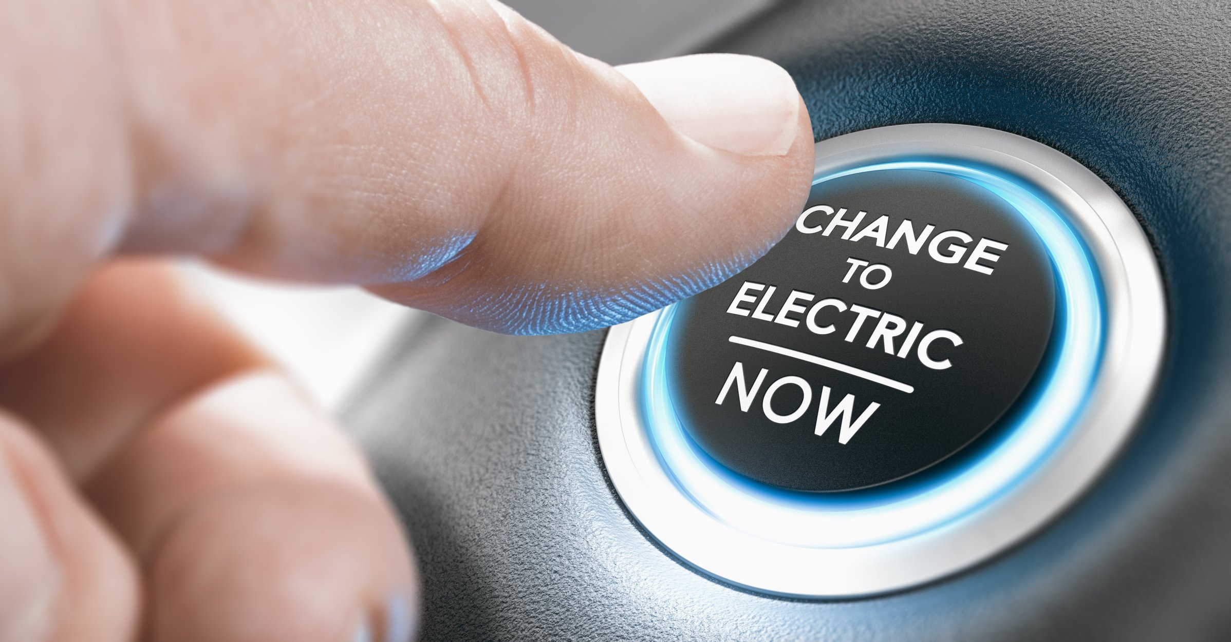 A finger pushing a button that says Change to electric now