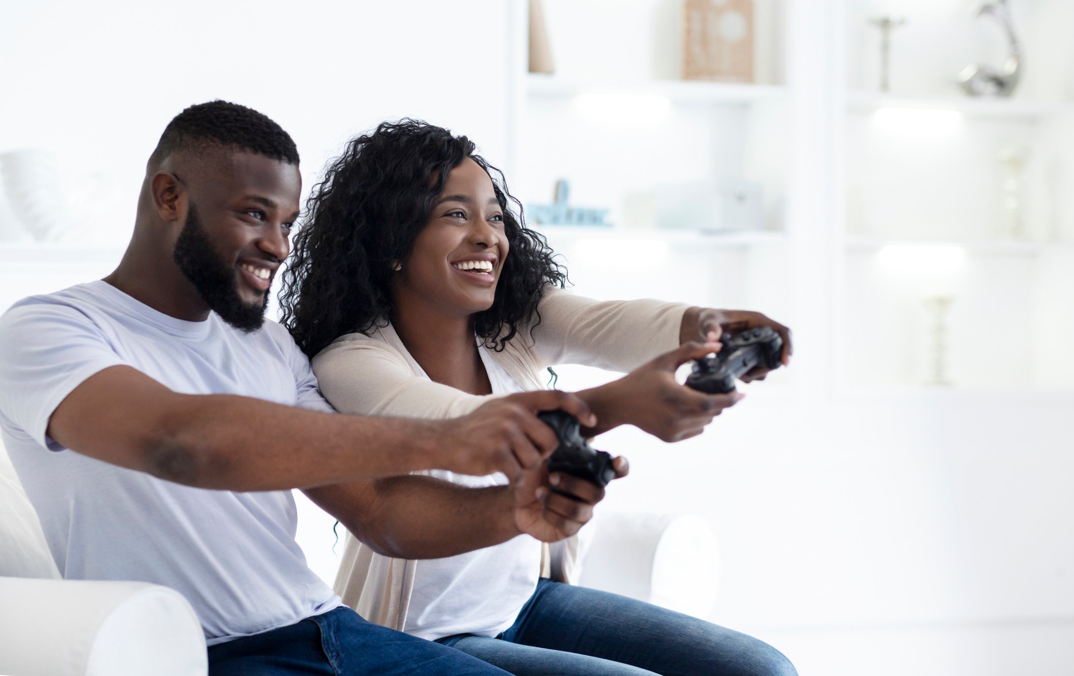 Young couple playing video games together.