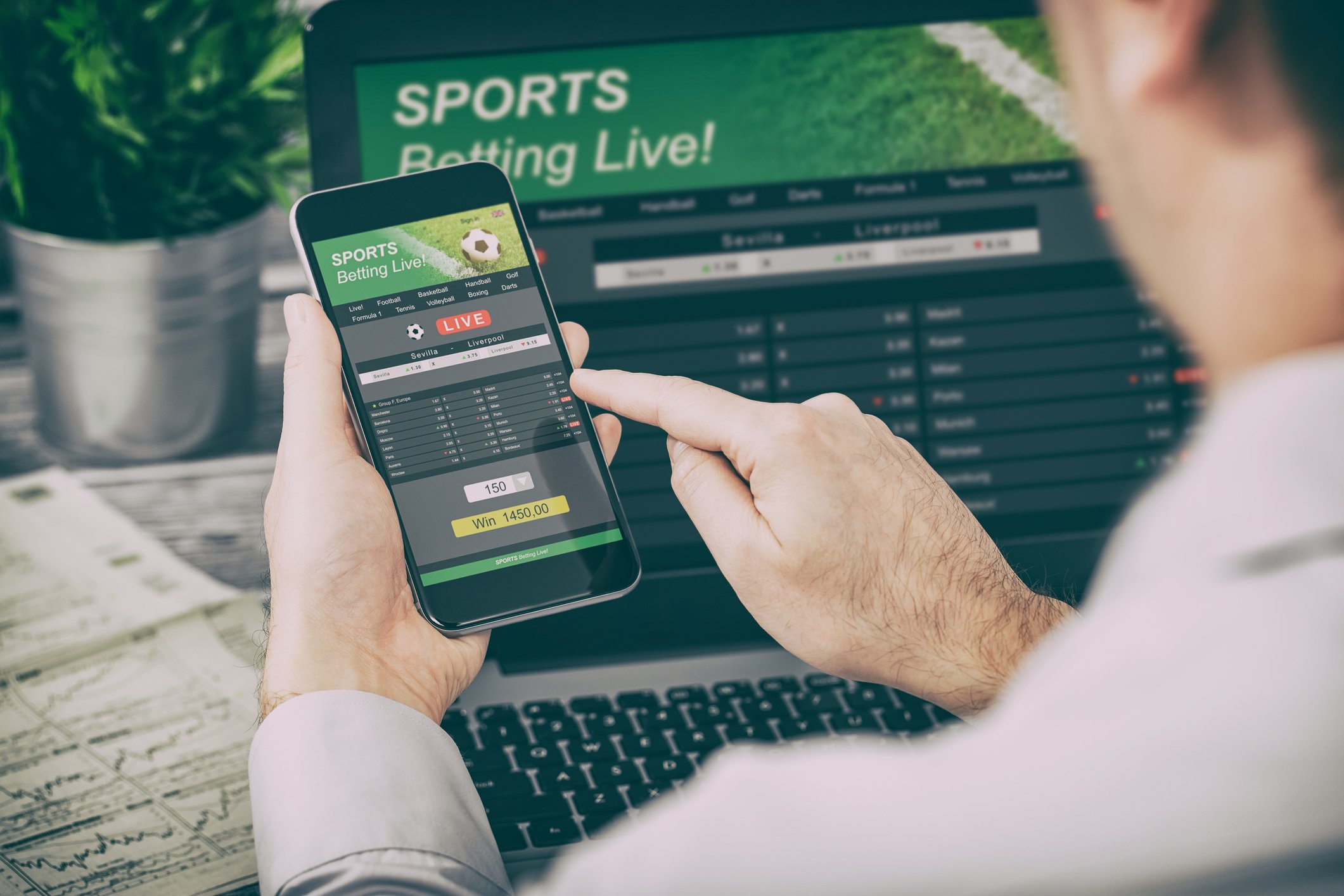 Man placing a sports bet on his phone