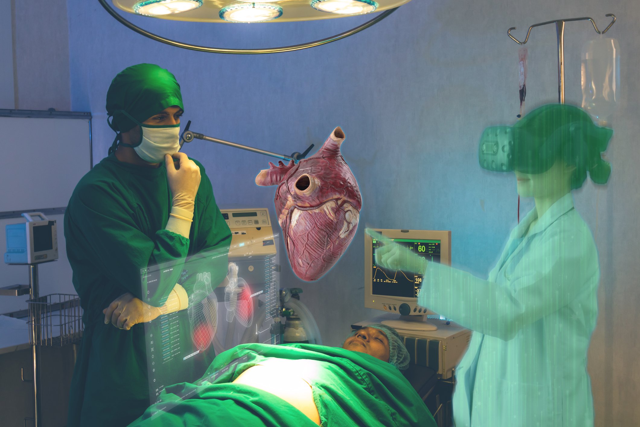 Two doctors in the operating room with a virtual heart hovering above the patient on the table.