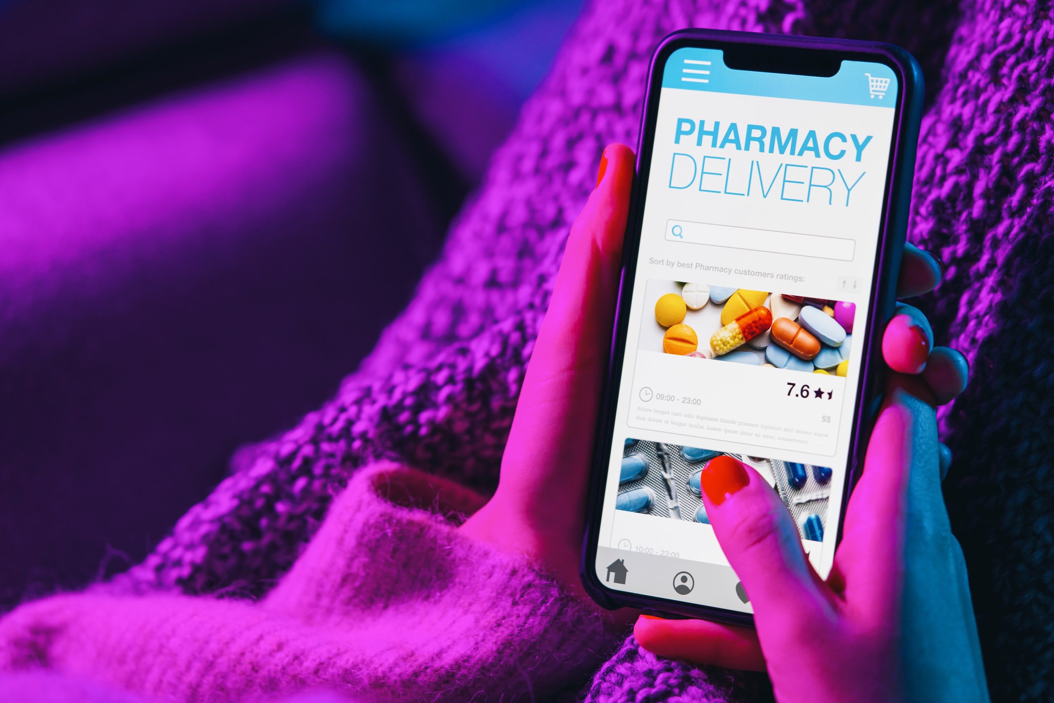 Woman holding a smartphone with an online pharmacy app open.