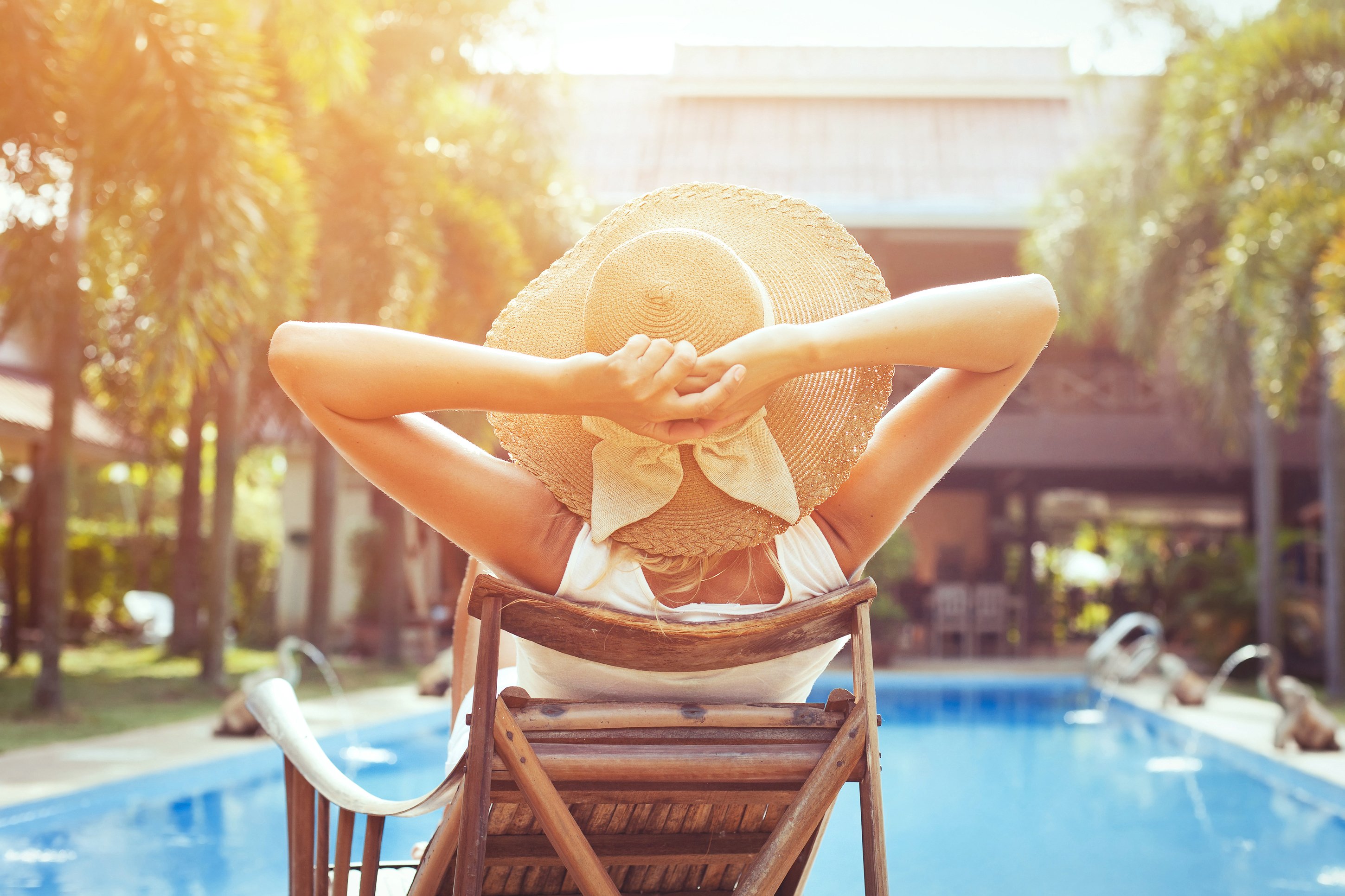 A woman relaxing by the hotel pool 