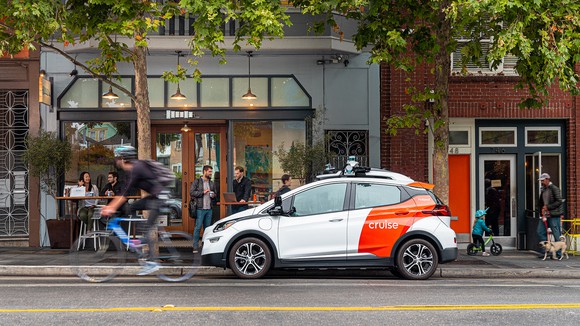 A Cruise AV, a self-driving taxi based on the Chevrolet Bolt, is shown parked on a San Francisco street. 