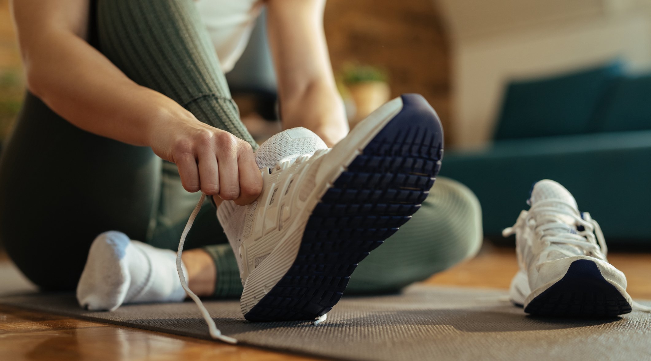 Woman putting on athletic shoes