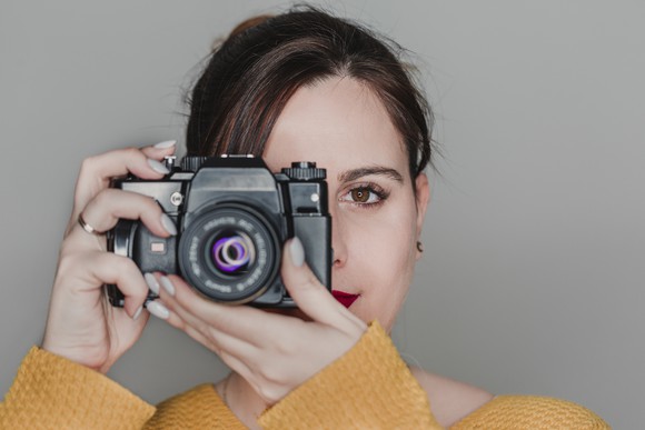 Woman holding a digital camera. 