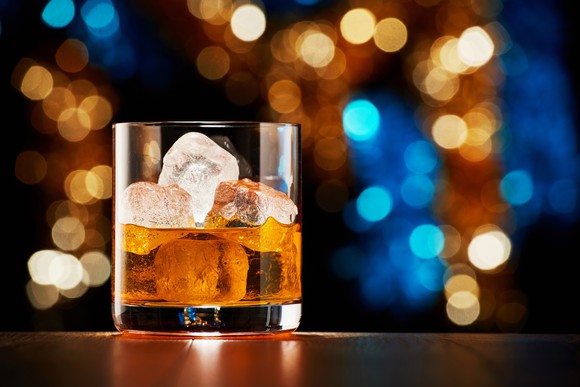 A glass of whiskey on the rocks.