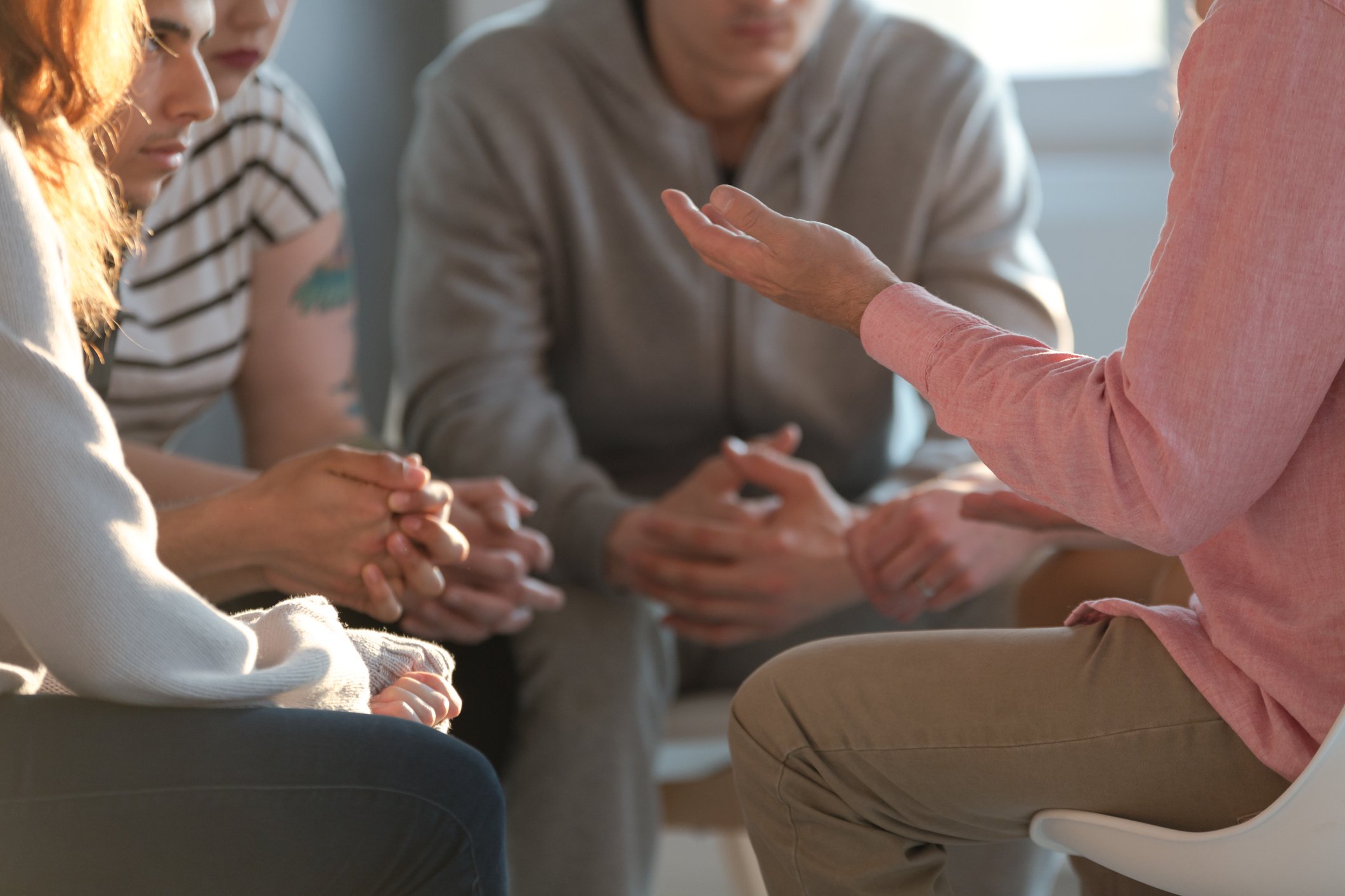 A group of people sitting around in a circle.