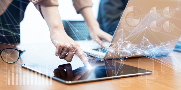 A person tapping on a tablet.