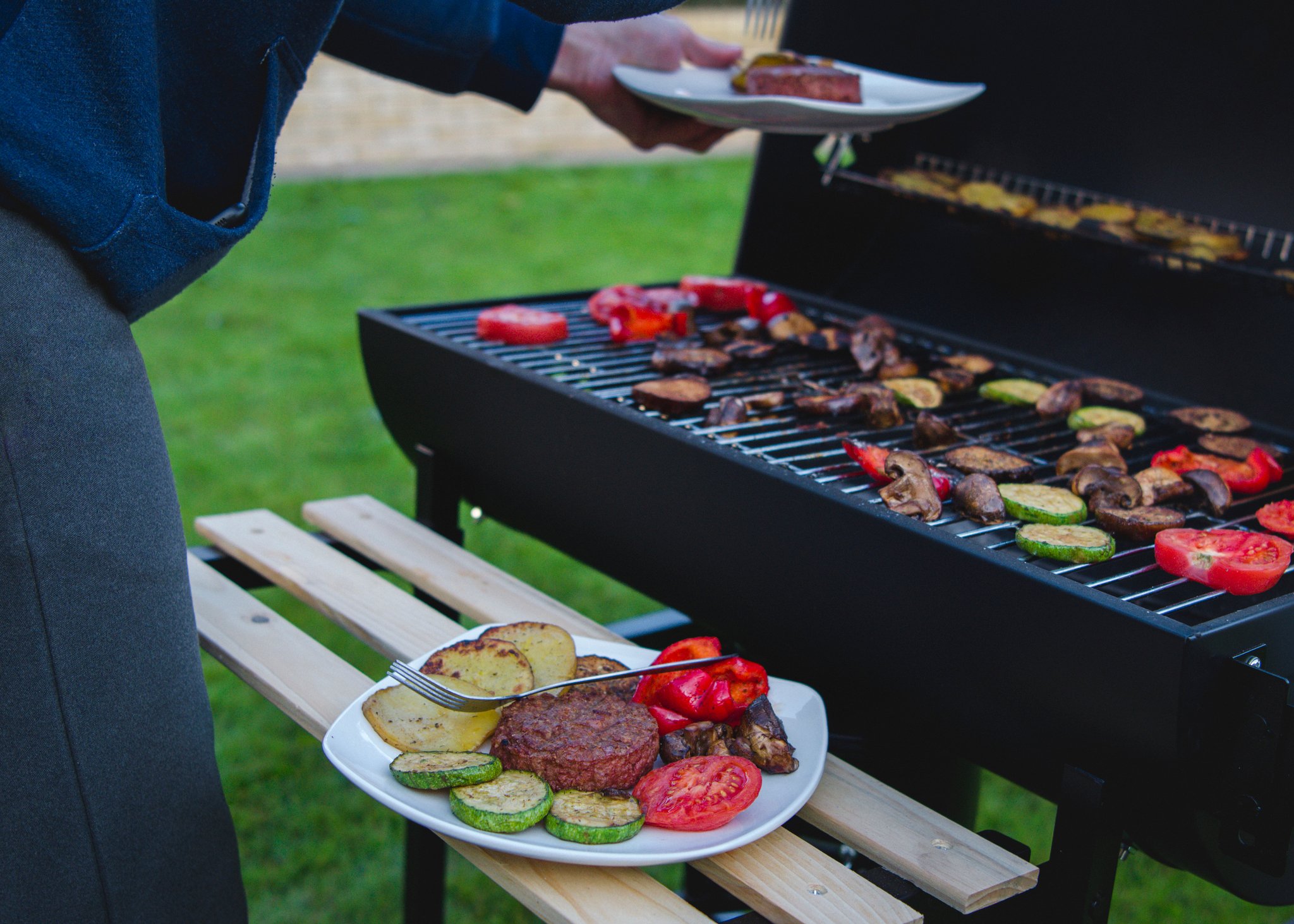 plant based meat with vegetables on a grill. 