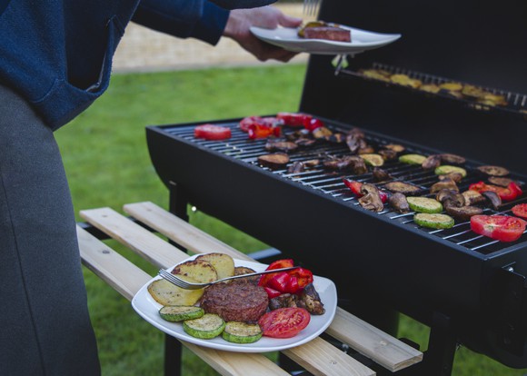 plant based meat with vegetables on a grill. 