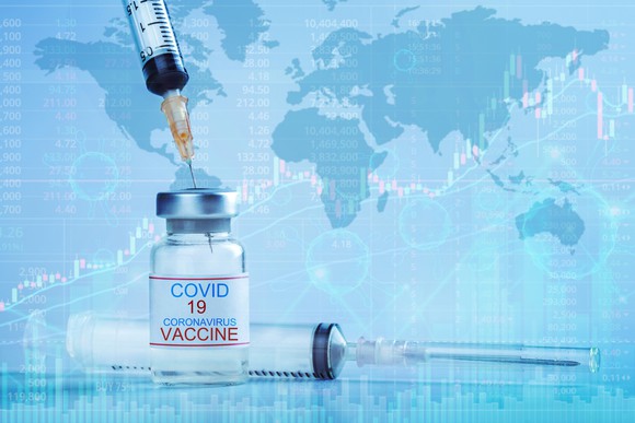 Coronavirus vaccine and syringe with world map in background