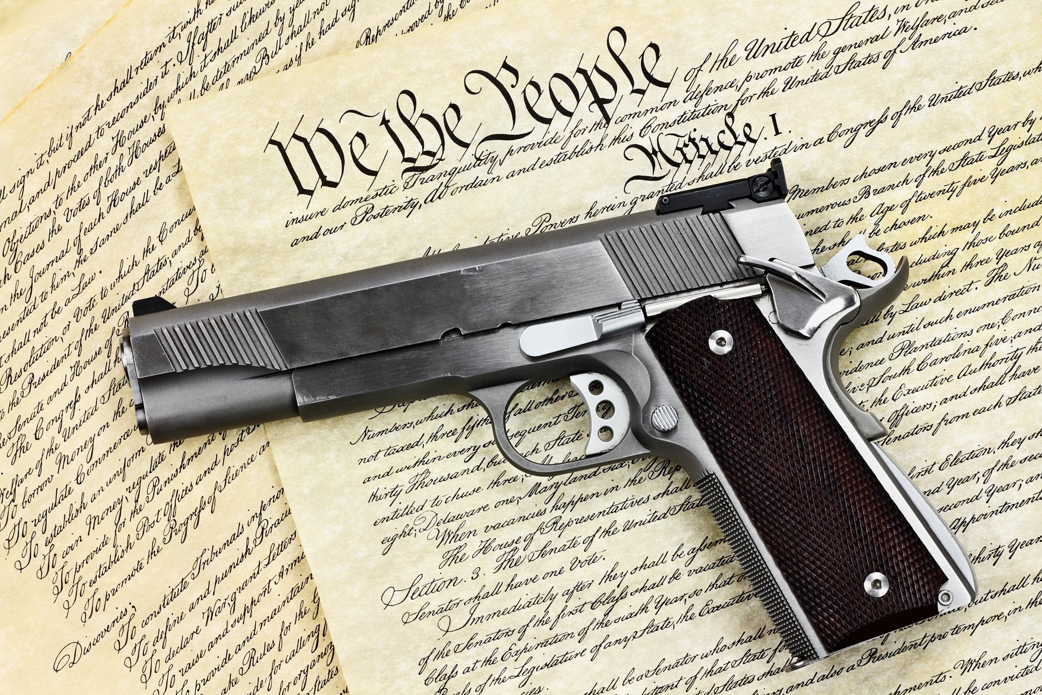 Handgun laying on Constitution