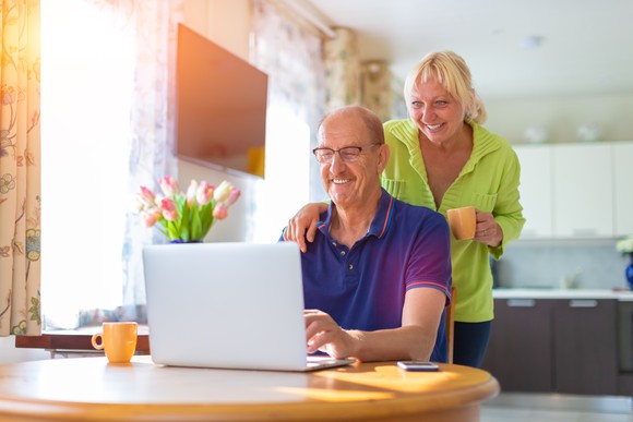 Senior man and woman looking at a laptop screen