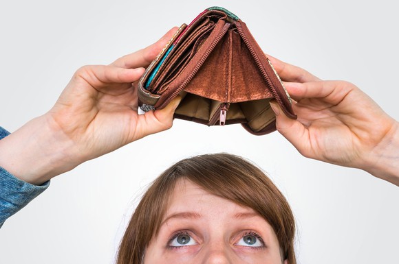 Person turning wallet upside down over head to show it's empty.