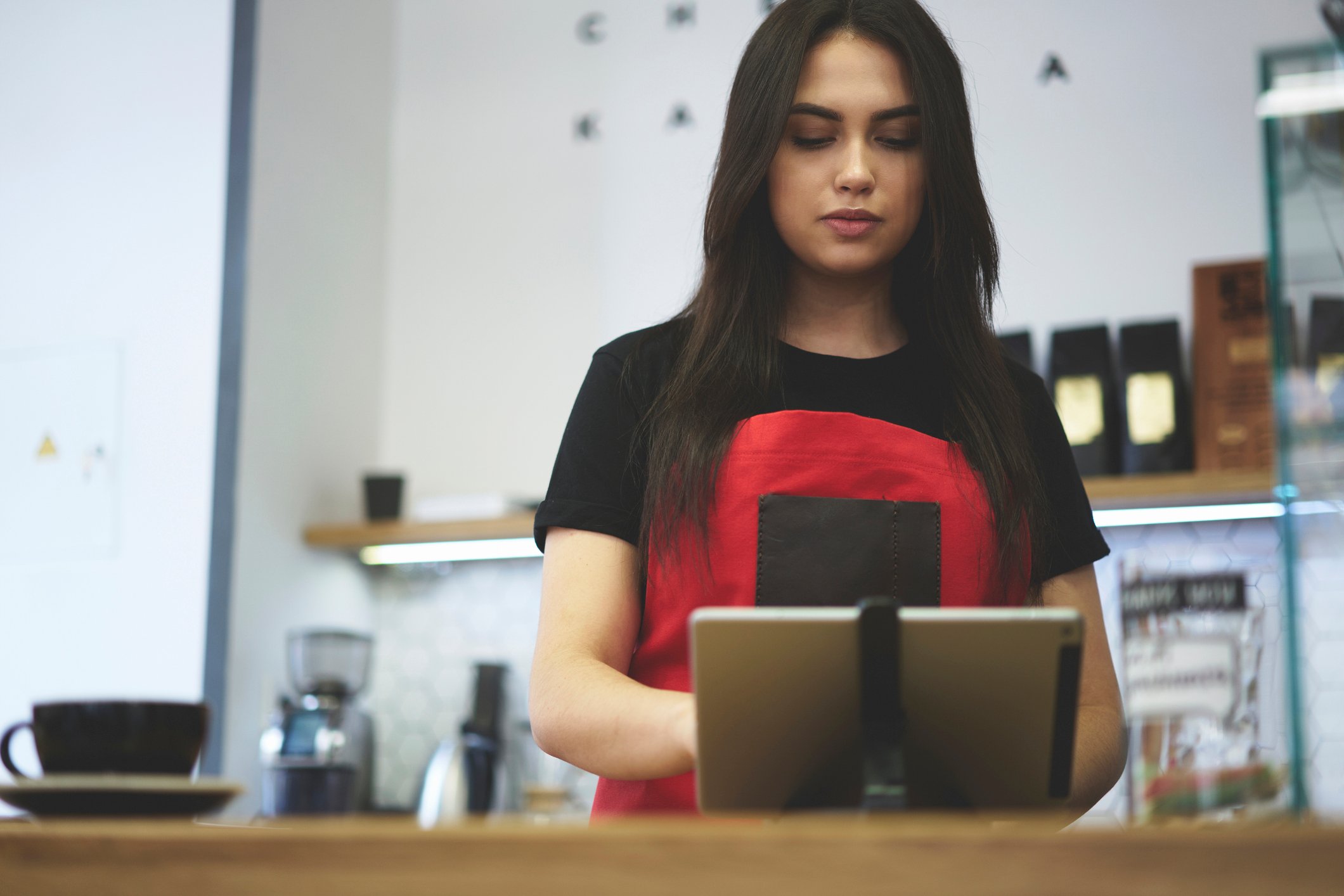 A cashier using a tablet.
