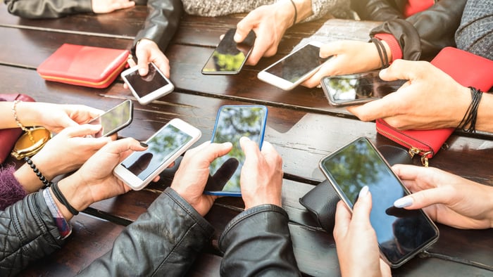 People holding smartphones.