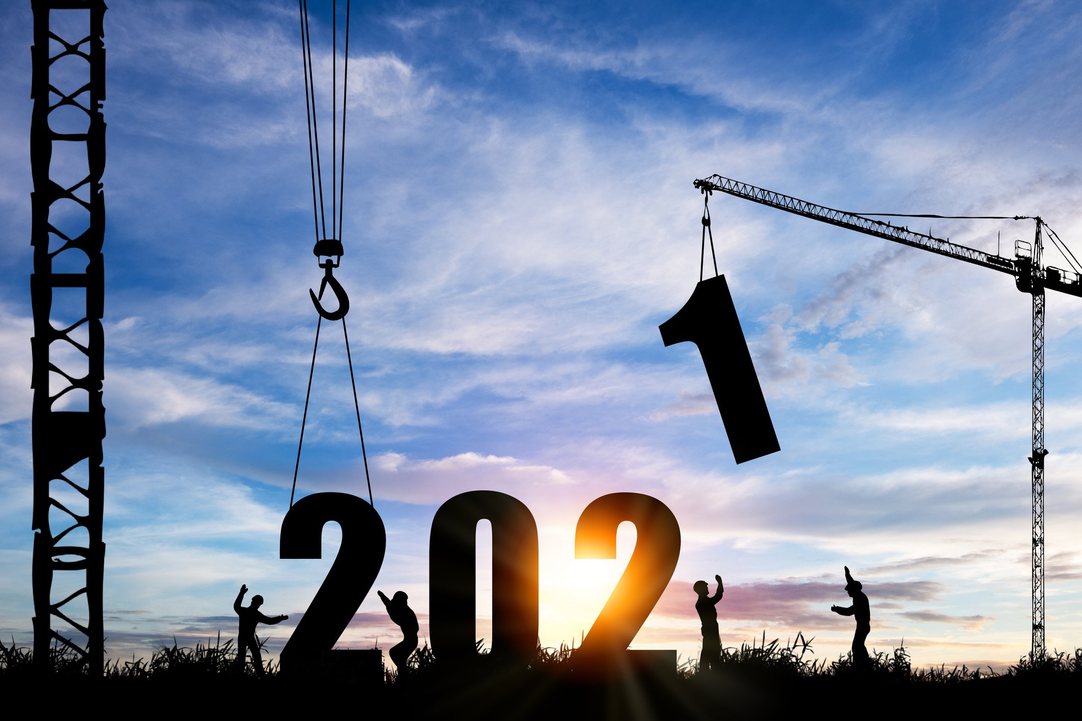 The silhouette of a construction crew bringing the number 1 down at the end of "2021"