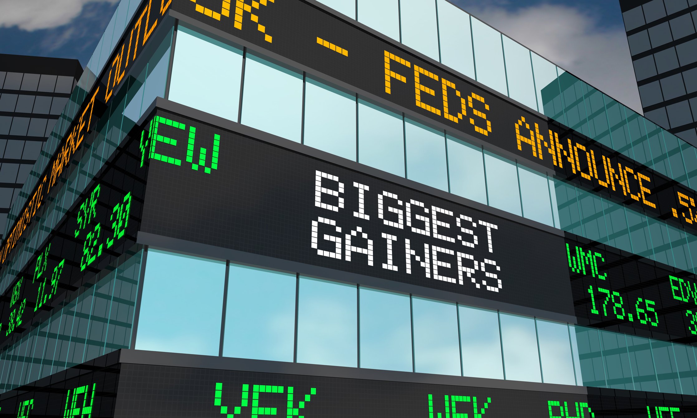 Stock ticker board on building showing the words Biggest Gainers