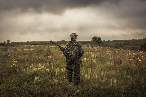 A hunter standing in a field