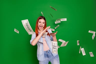 Excited woman scattering $100 bills