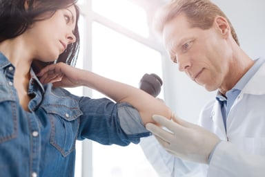 Doctor checking a woman's skin