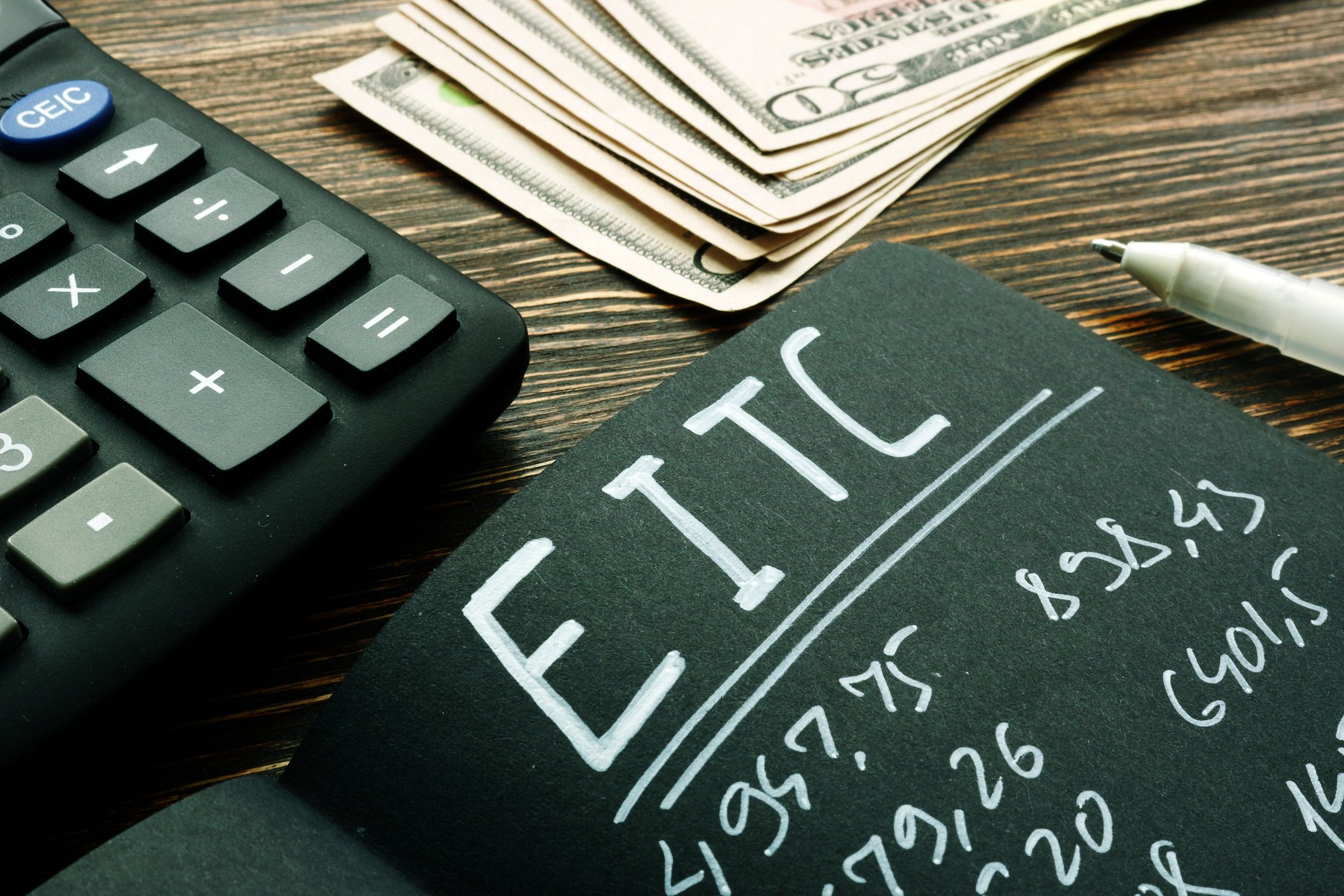 EITC Earned income tax credit calculations on a black notebook page.