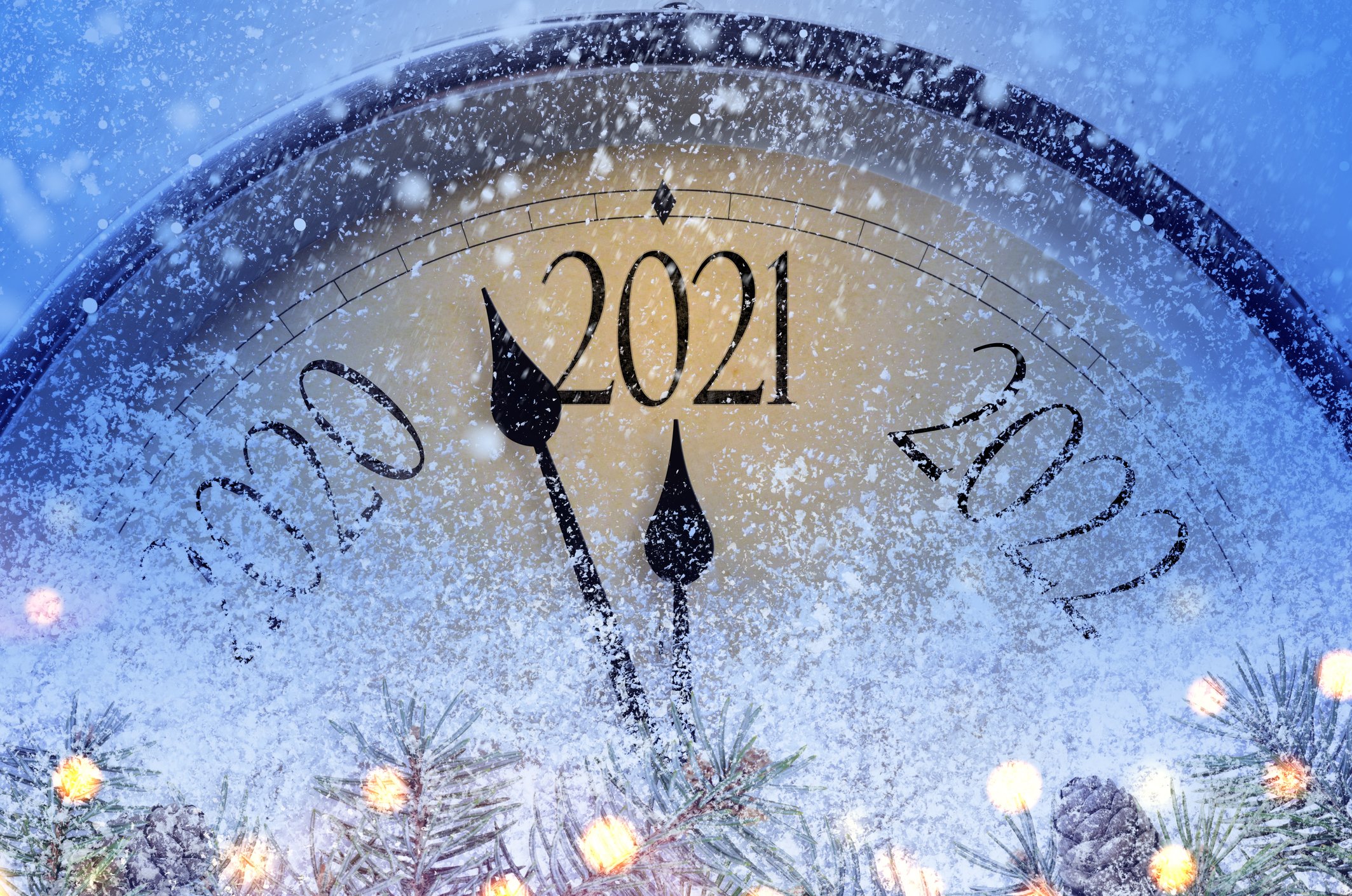 A giant clock, face mostly frosted, with hands moving to 2021