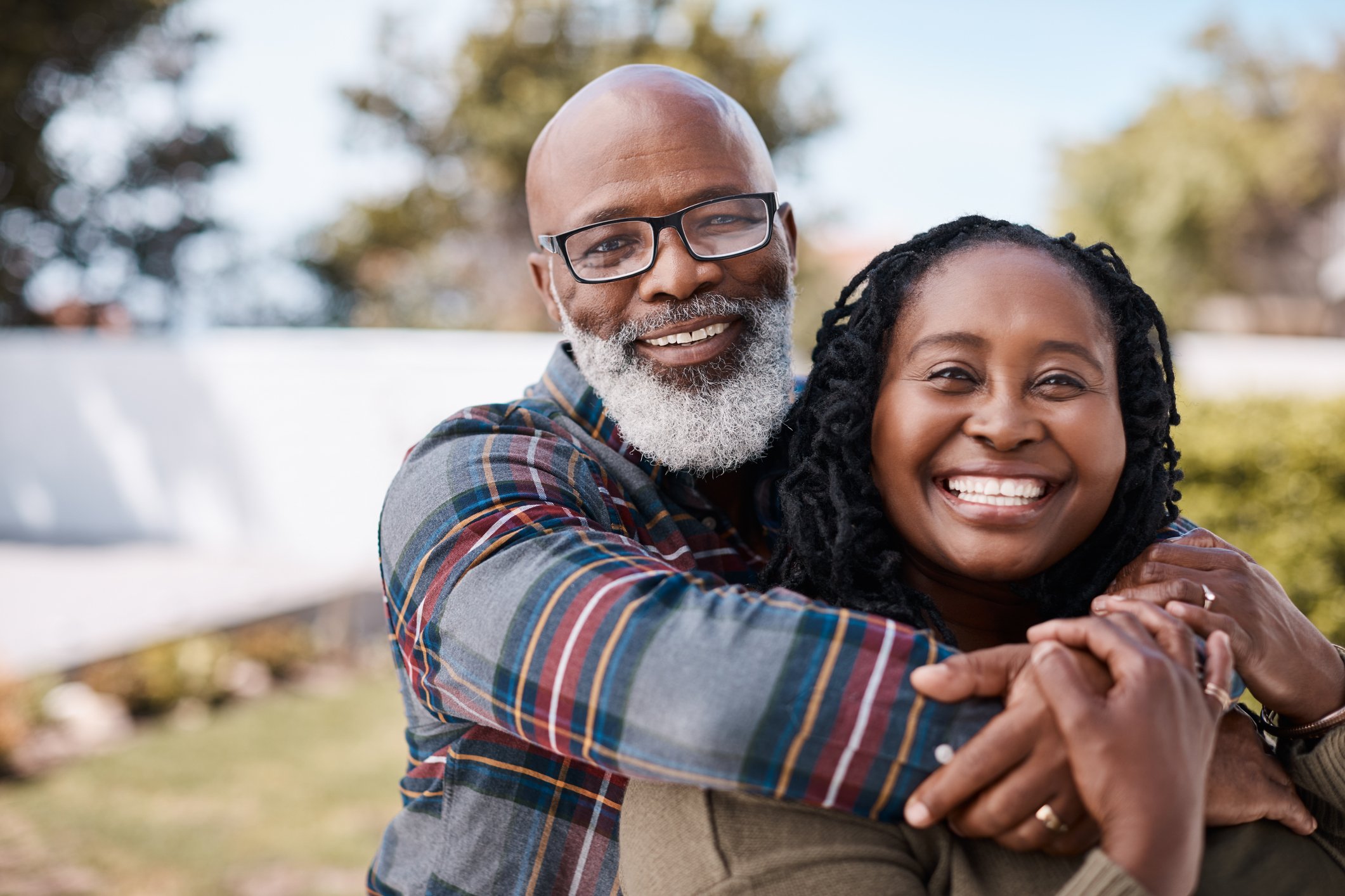 Smiling senior man and woman embracing