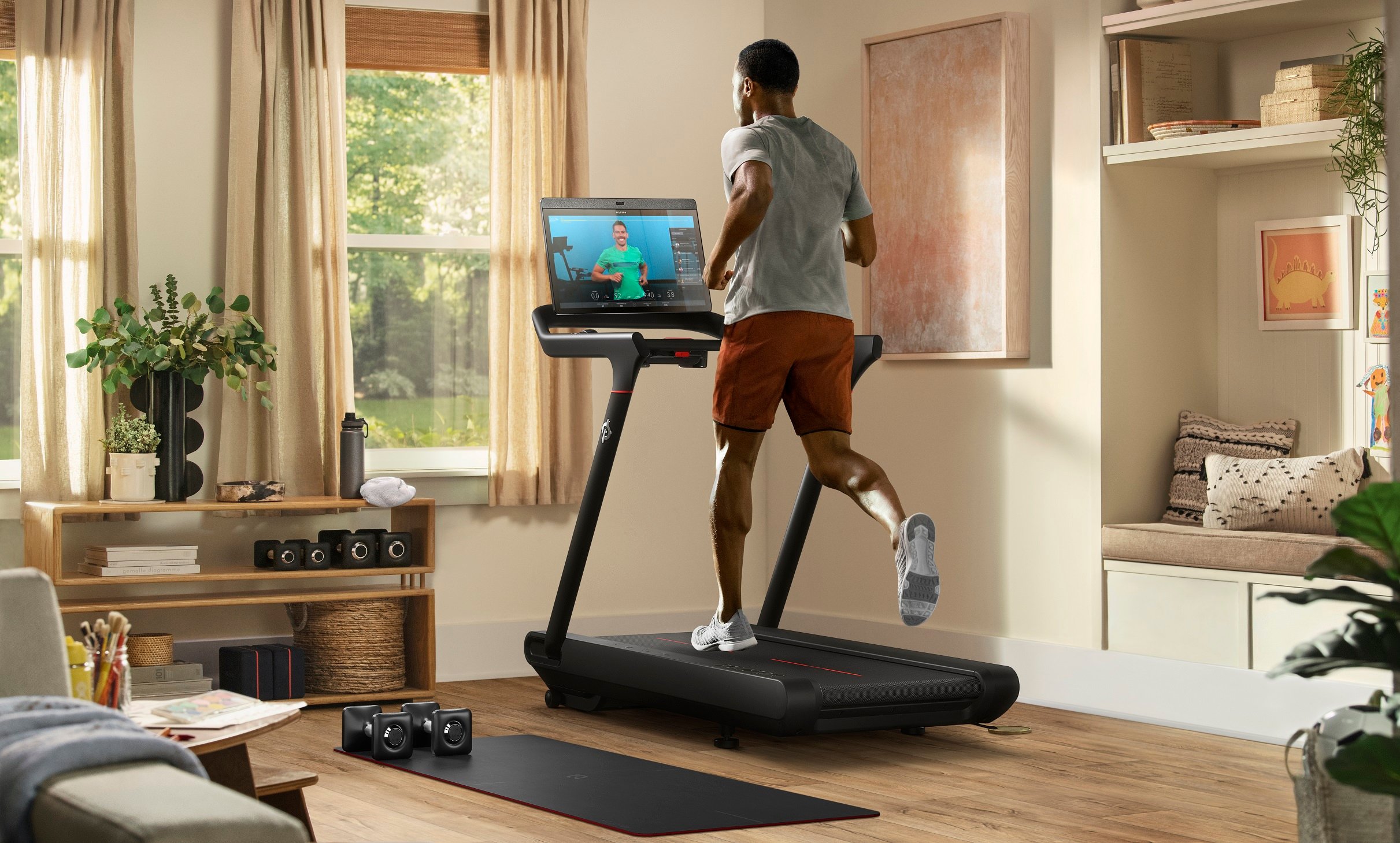 Peloton customer running on a Peloton treadmill.