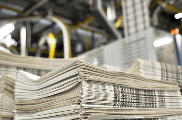 A stack of newspapers at a printing press