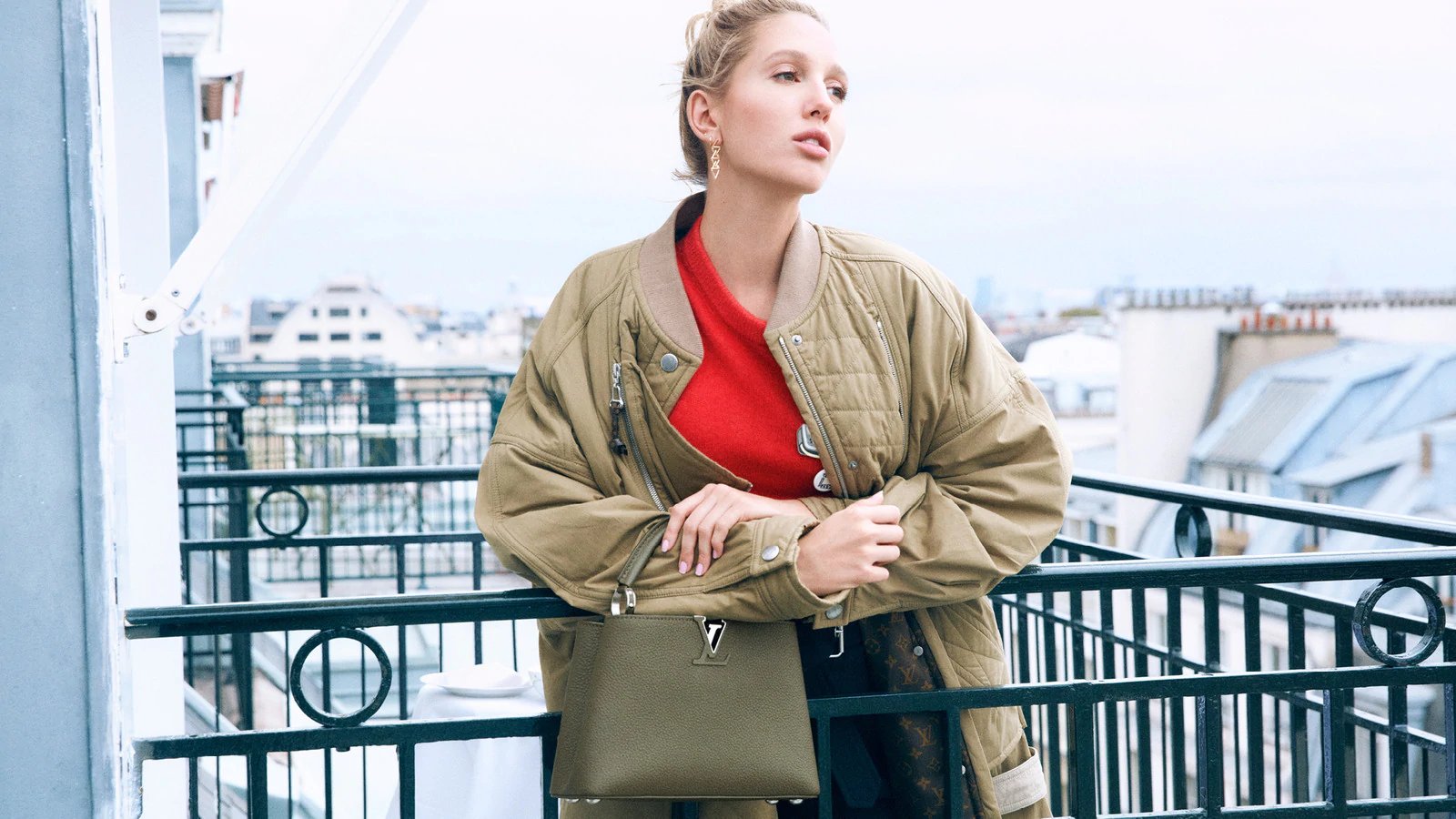 A woman holding an LV Capucine bag.
