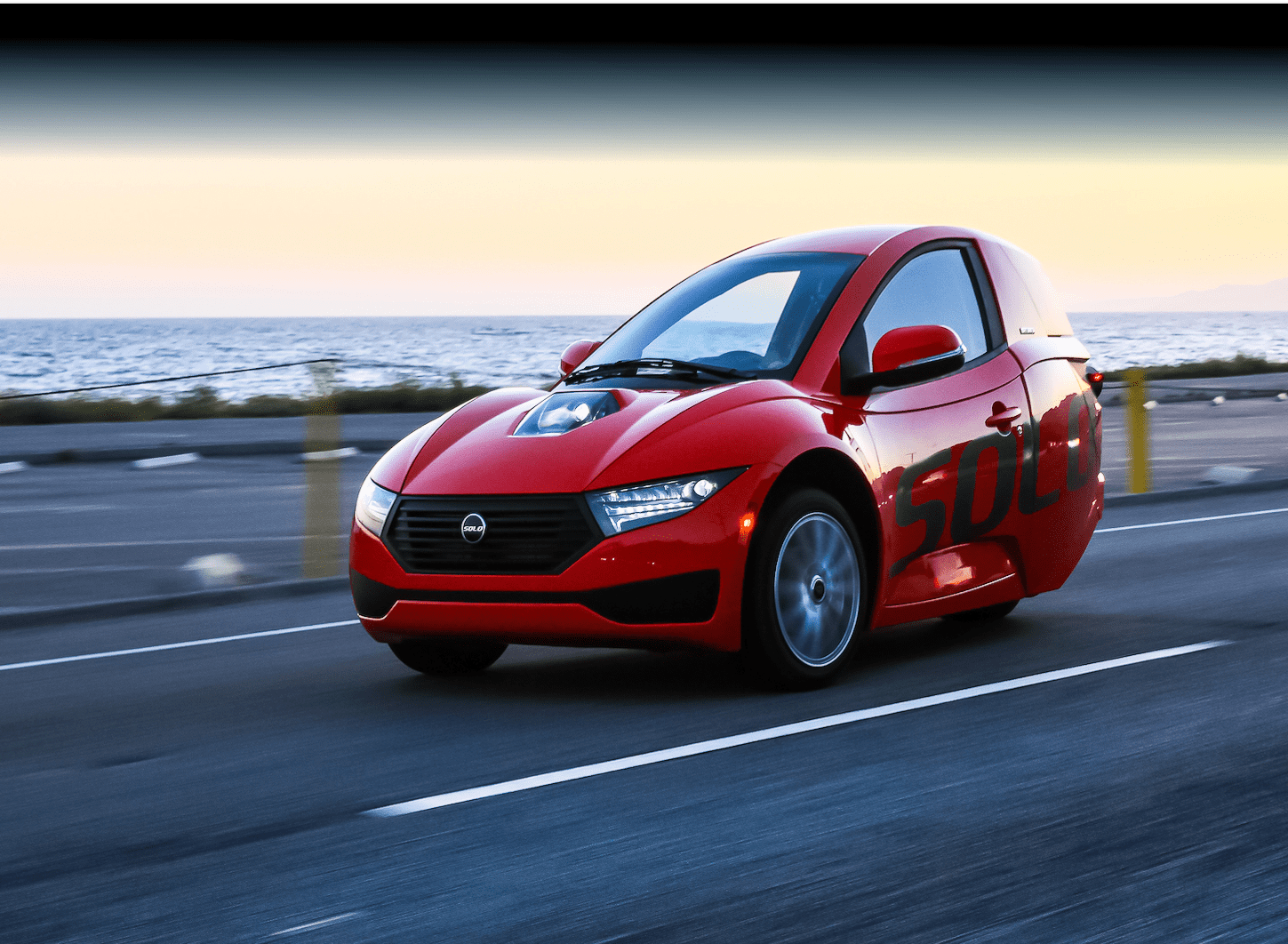 An Electrameccanica Solo vehicle driving on a road.