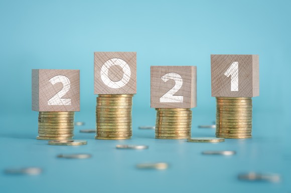 2021 blocks on top of stacks of coins