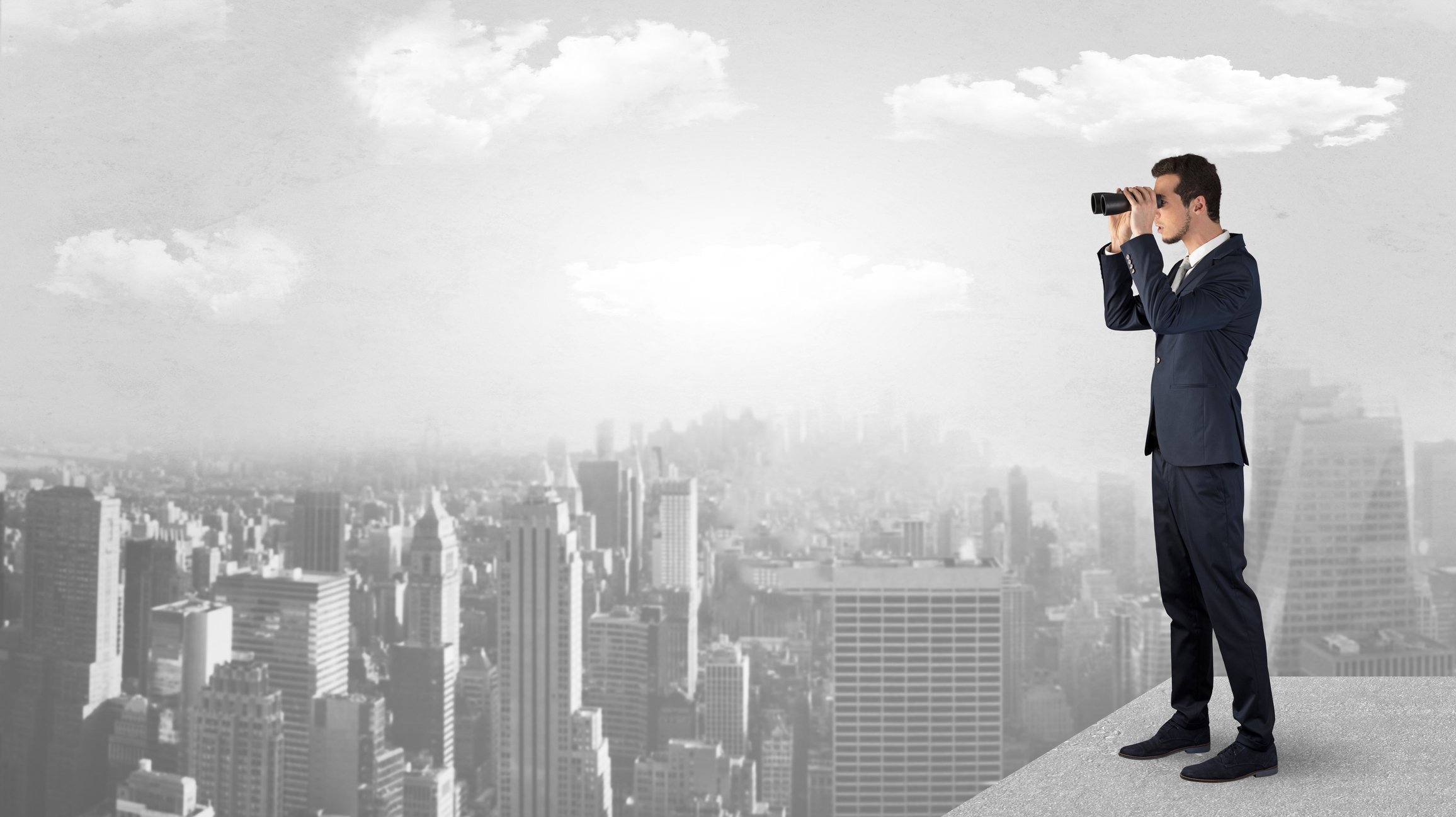 Rendering of a businessman standing atop a tall skyscraper, viewing the city through binoculars.