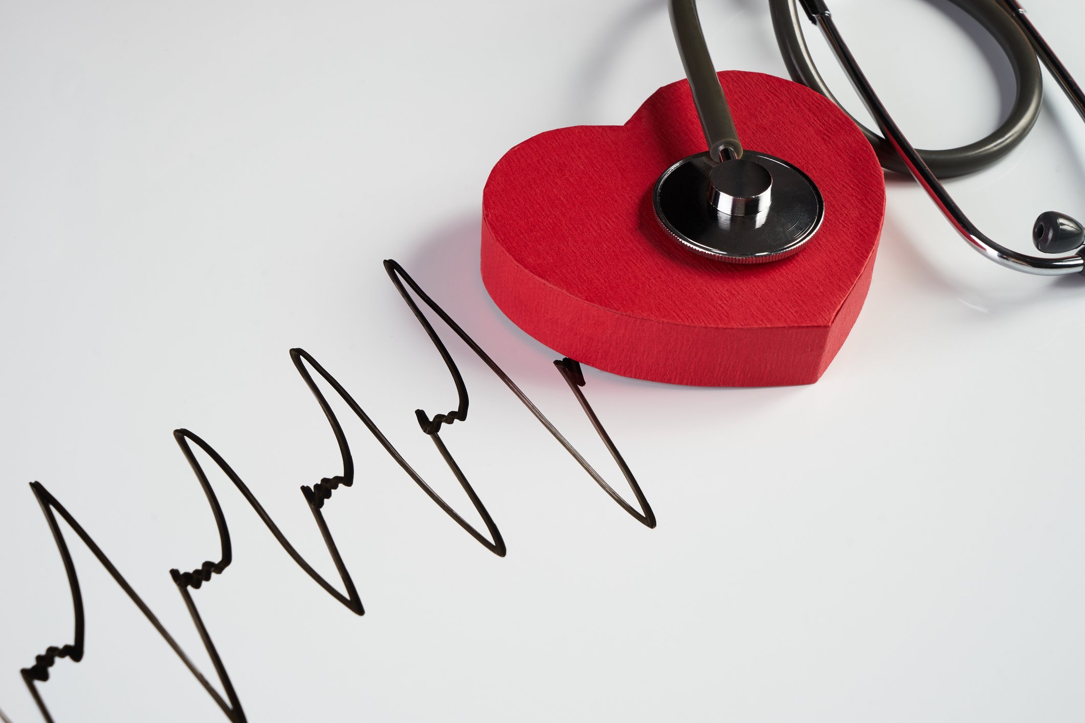 Stethoscope and red heart with cardiogram pattern