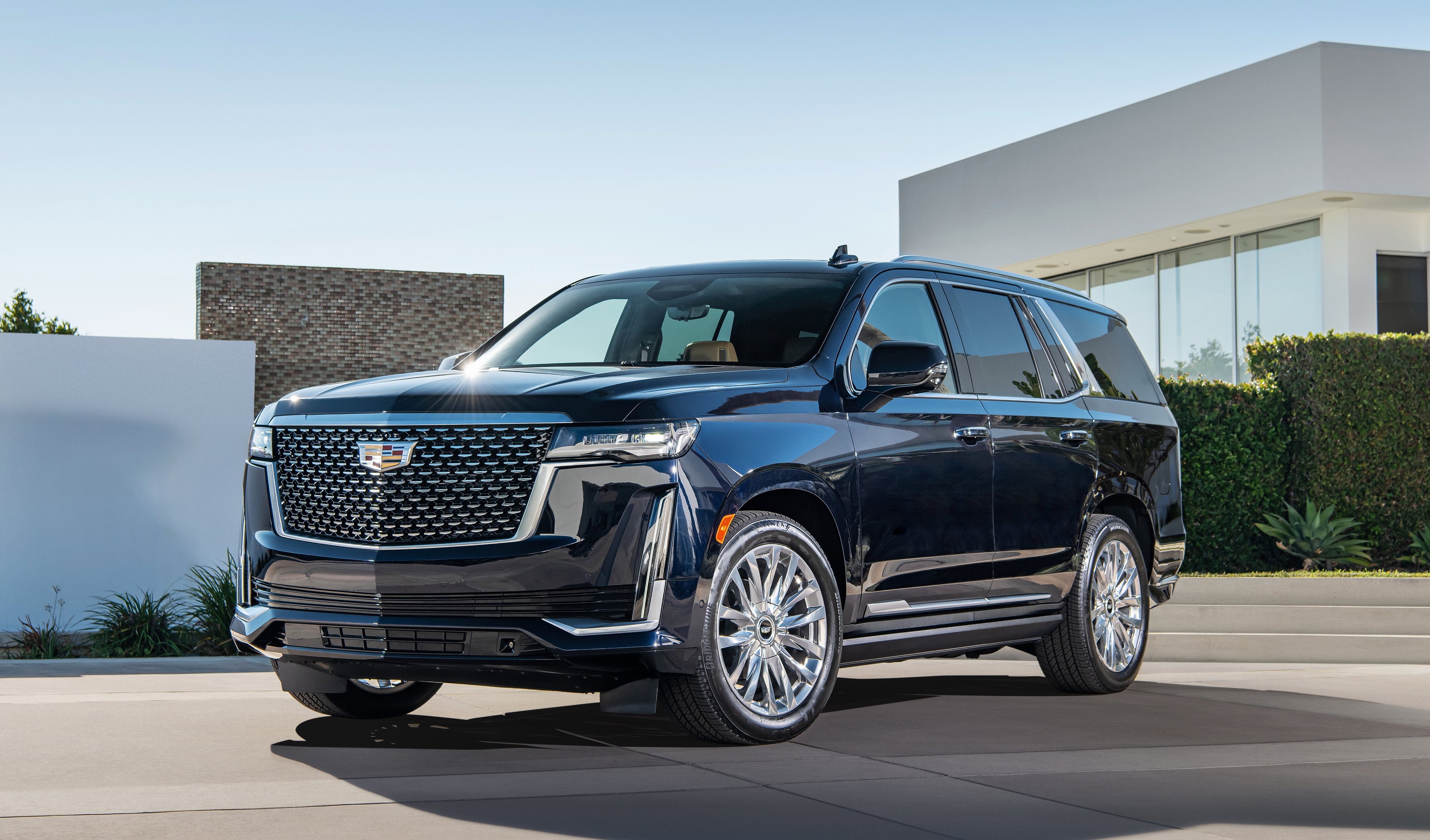 A black 2021 Cadillac Escalade, a large luxury SUV.