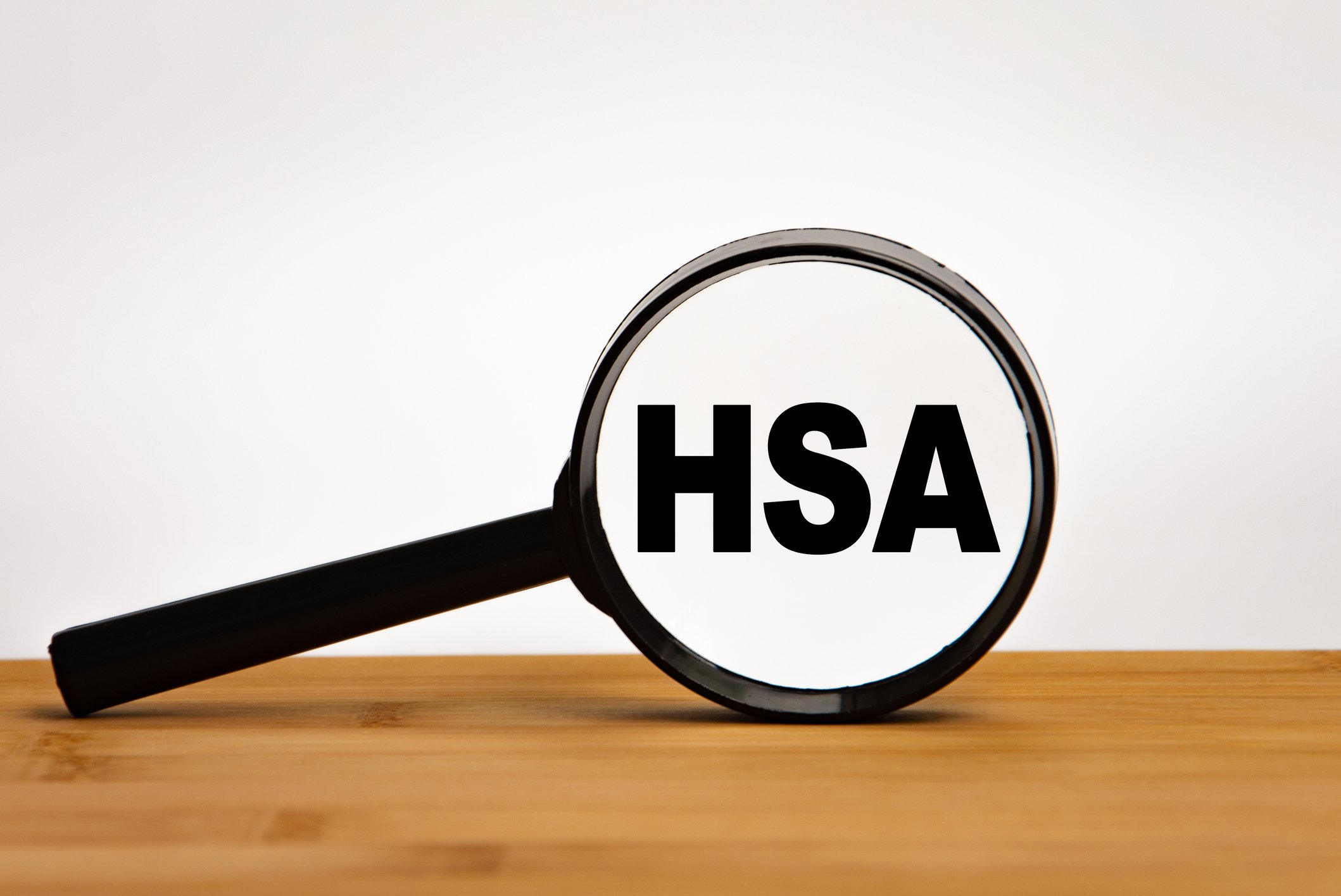 Magnifying glass focused on the letters "HSA"