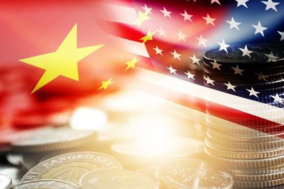U.S. and China flags superimposed above a picture of coins.