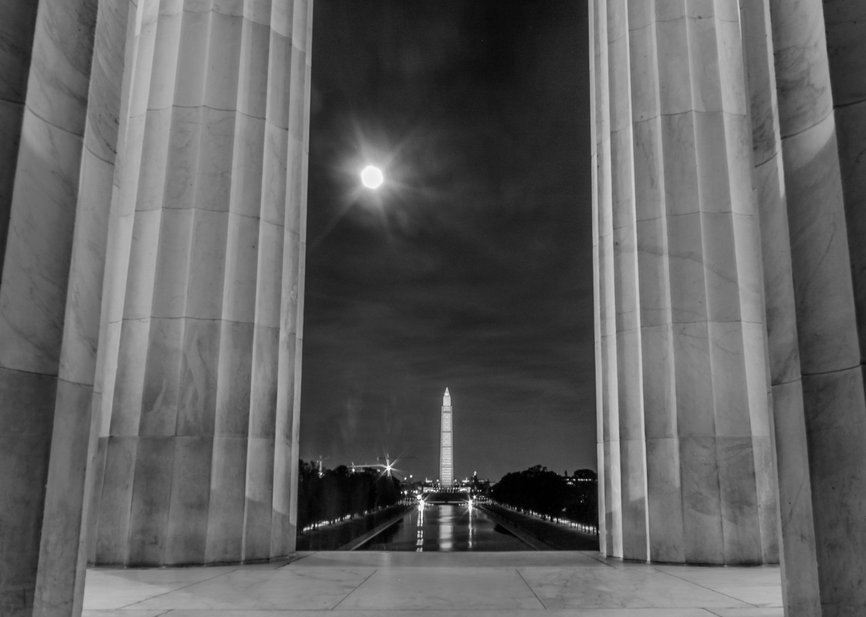 National Mall as seen from Lincoln Memorial, showing Washington Monument and near-full moon.