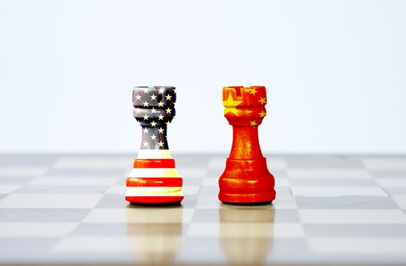 two chess pawns painted with the U.S. and Chinese flag colors
