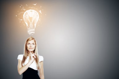 Light bulb going on over smiling woman's head