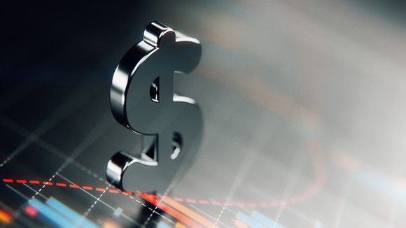 Metal dollar sign on top of a graph. 