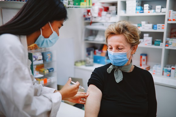 Patient receiving a coronavirus vaccine at a pharmacy. 
