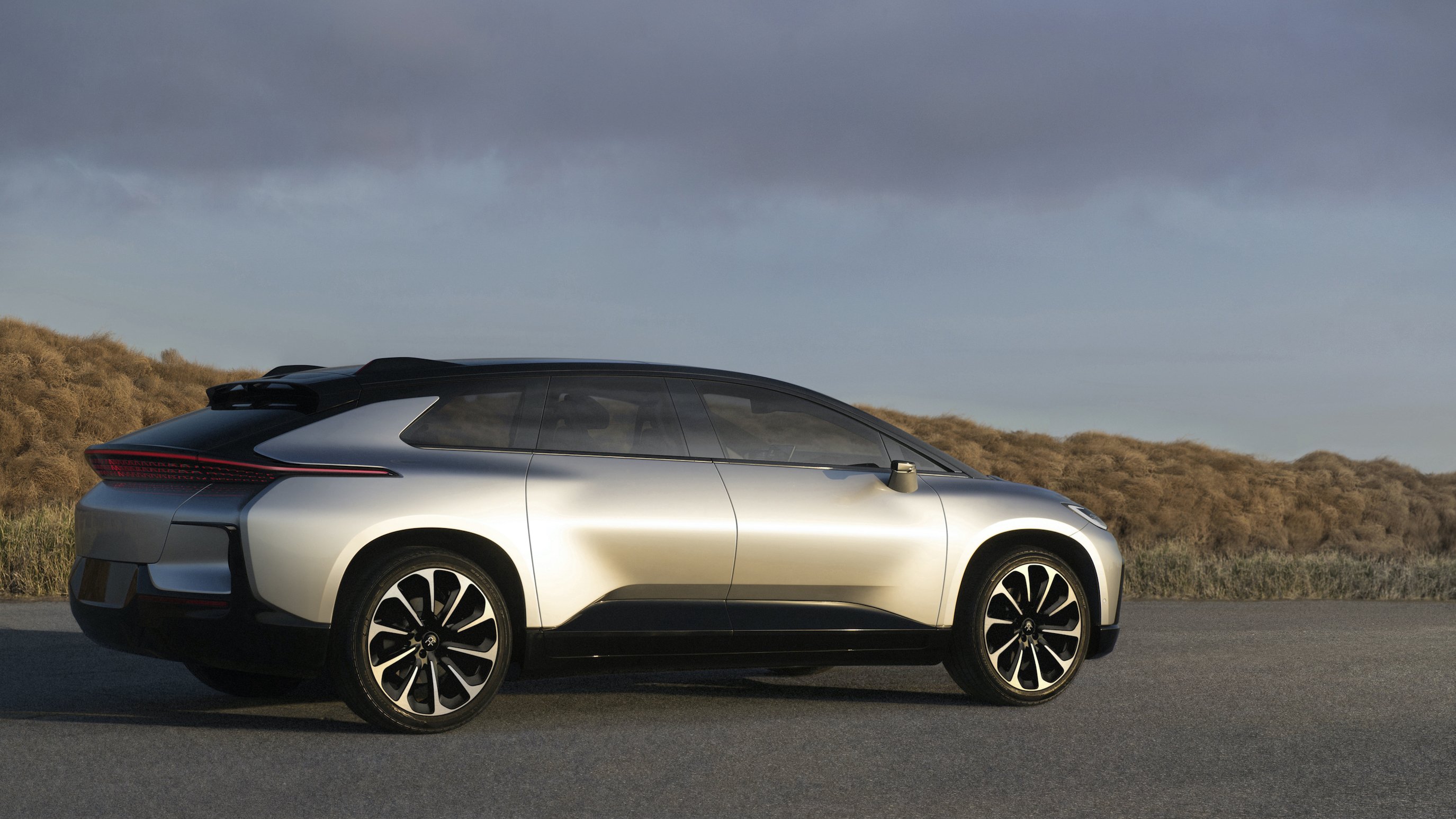 A silver Faraday FF 91, a futuristic-looking crossover. 