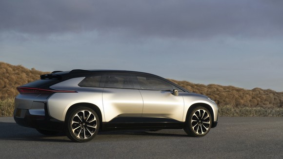 A silver Faraday FF 91, a futuristic-looking crossover. 
